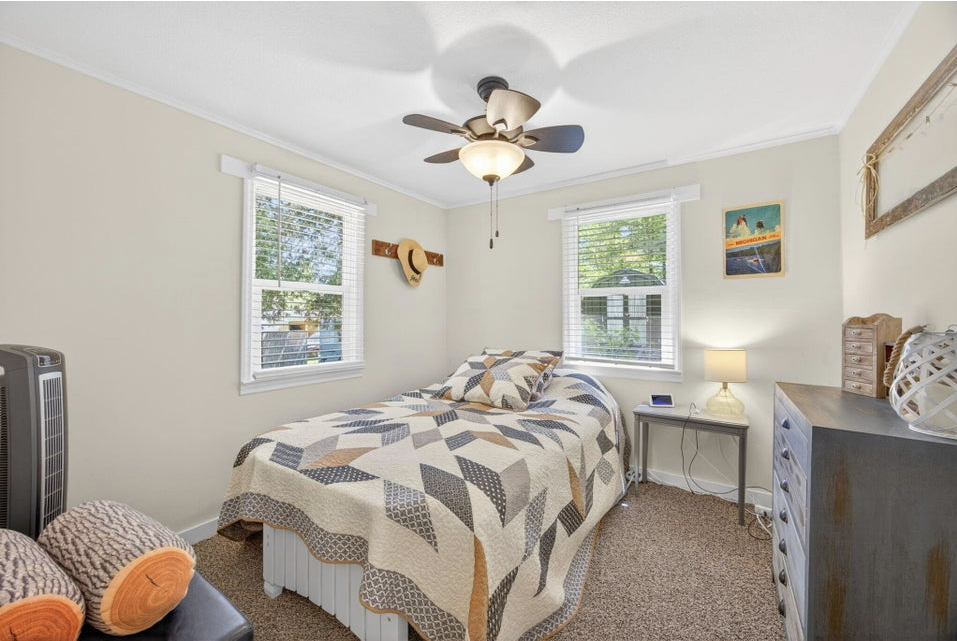 Bedroom with ceiling fan and natural light