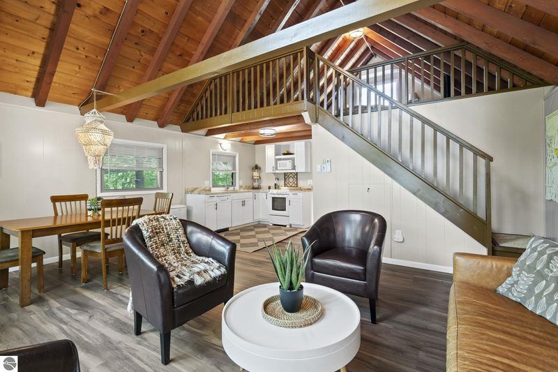 Open living and kitchen under vaulted beams